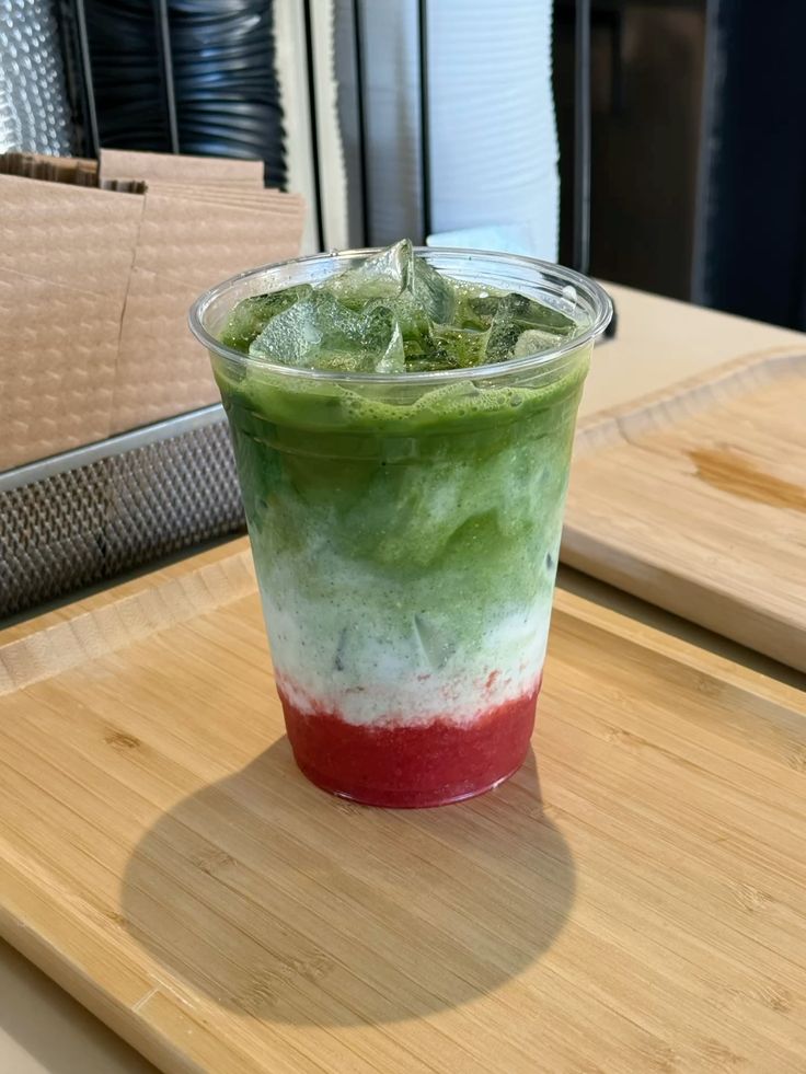 Layered strawberry iced matcha latte made with Matcha Ujiro and fresh strawberries