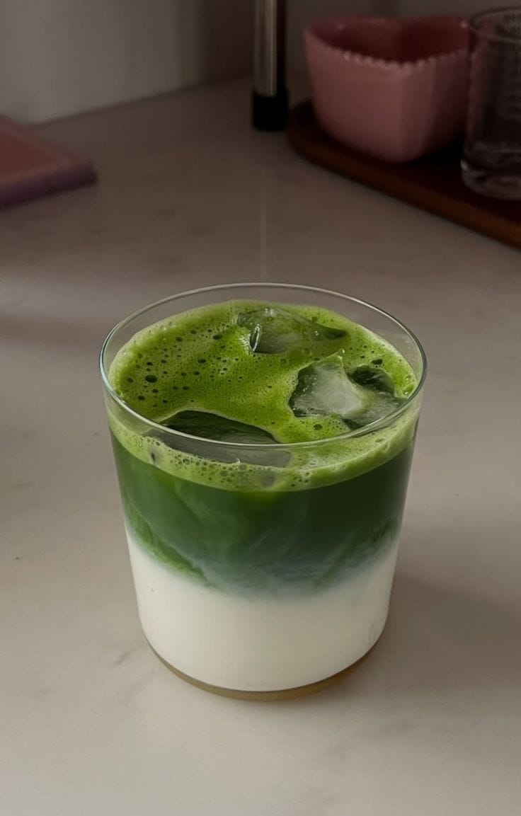 Iced matcha oat latte in a tall glass with ice made with Matcha Ujiro